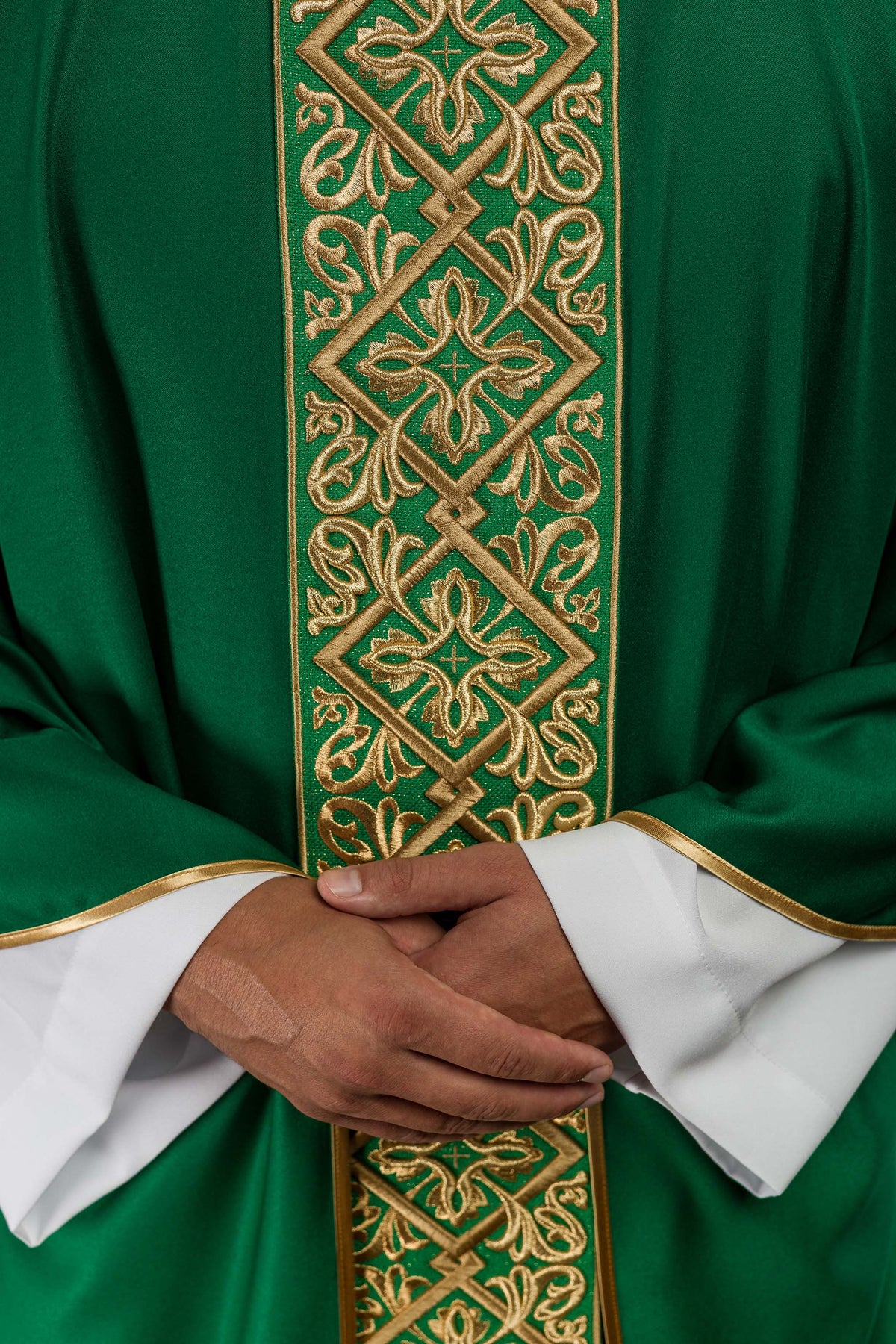 Casula verde com faixa central bordada em dourado, exibindo flores, cruzes e arabescos