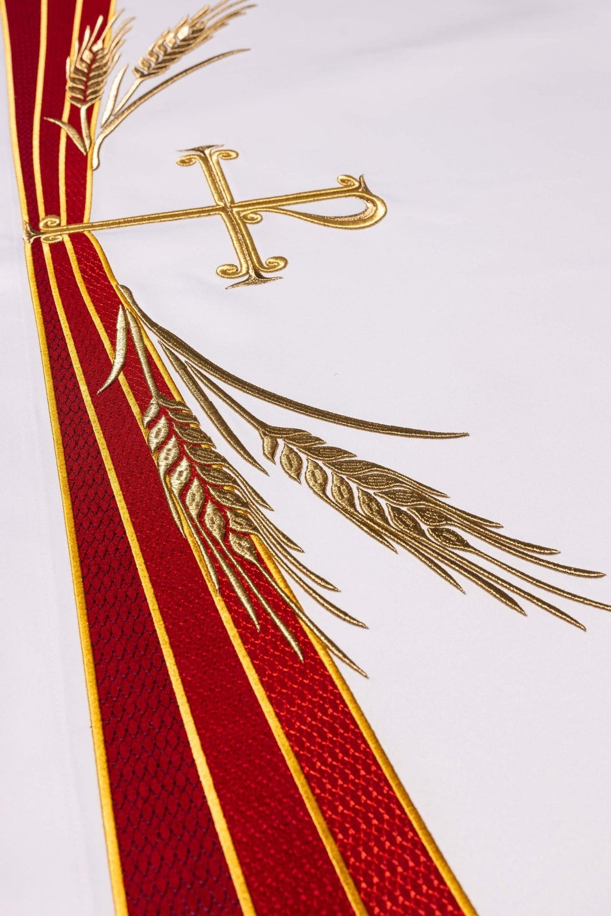 Toalha de altar com símbolo PAX, detalhe do bordado dourado de espigas de trigo e faixas vermelhas
