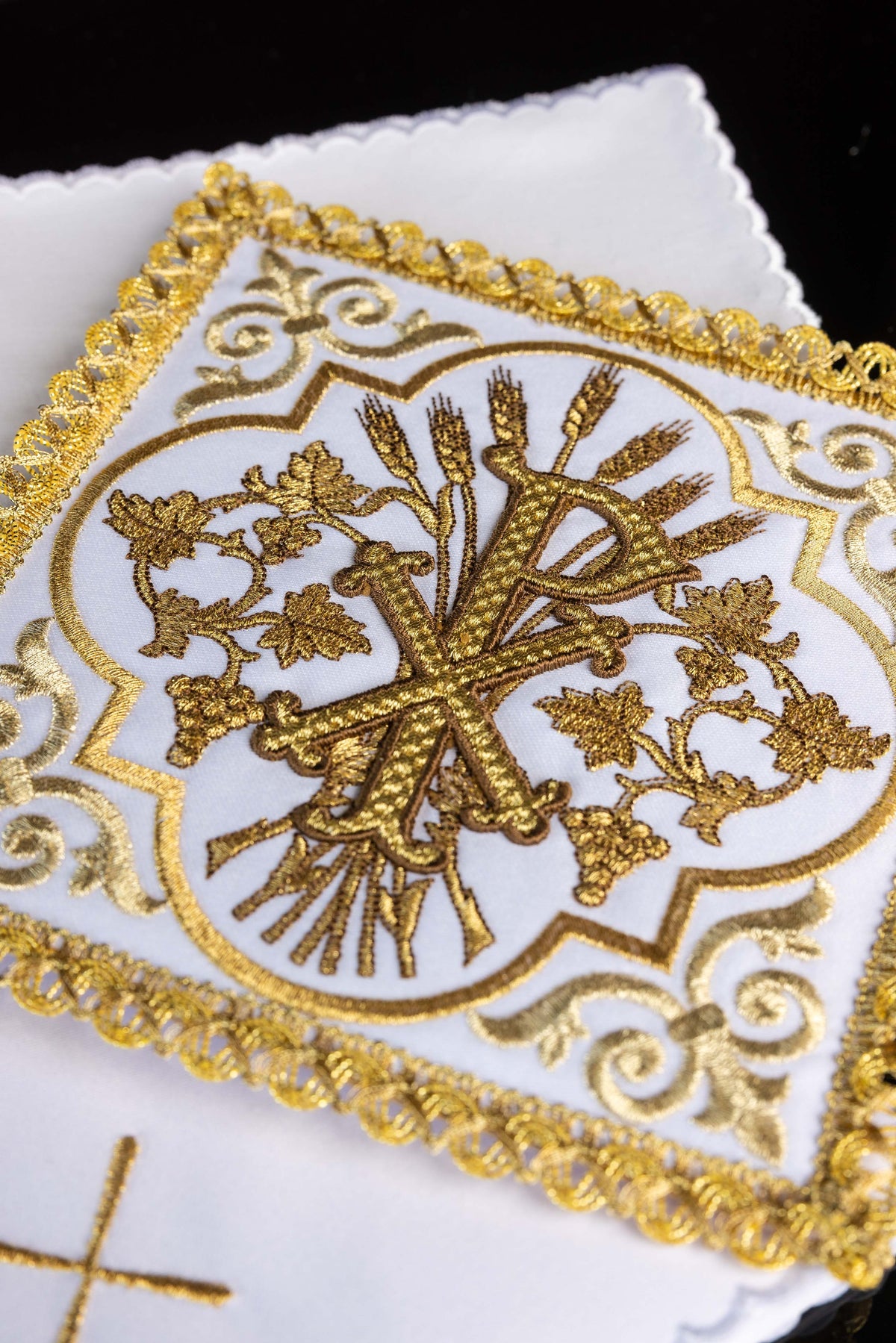 Alfaias litúrgicas brancas com bordado PAX, arabescos dourados e borda decorativa