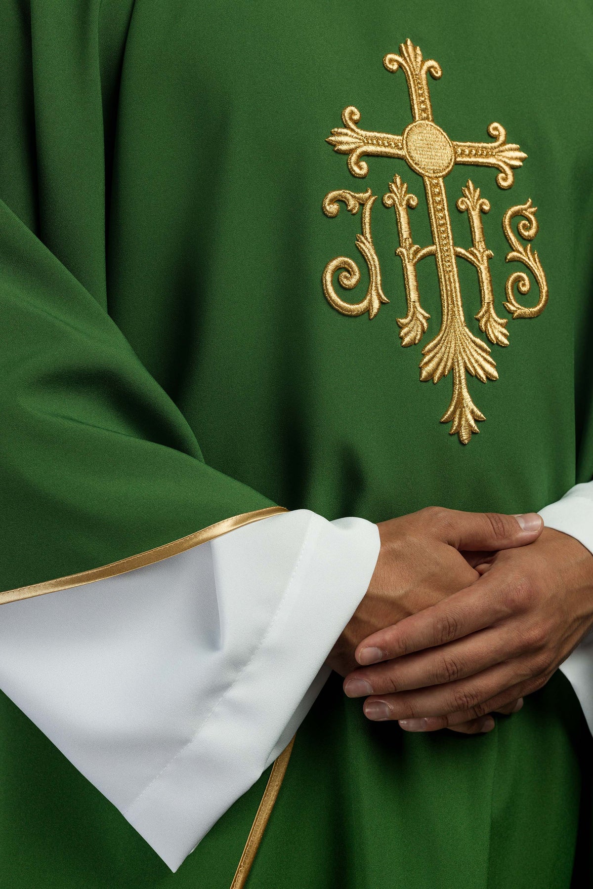 Casula verde com bordado IHS em detalhe, com acabamento dourado na manga