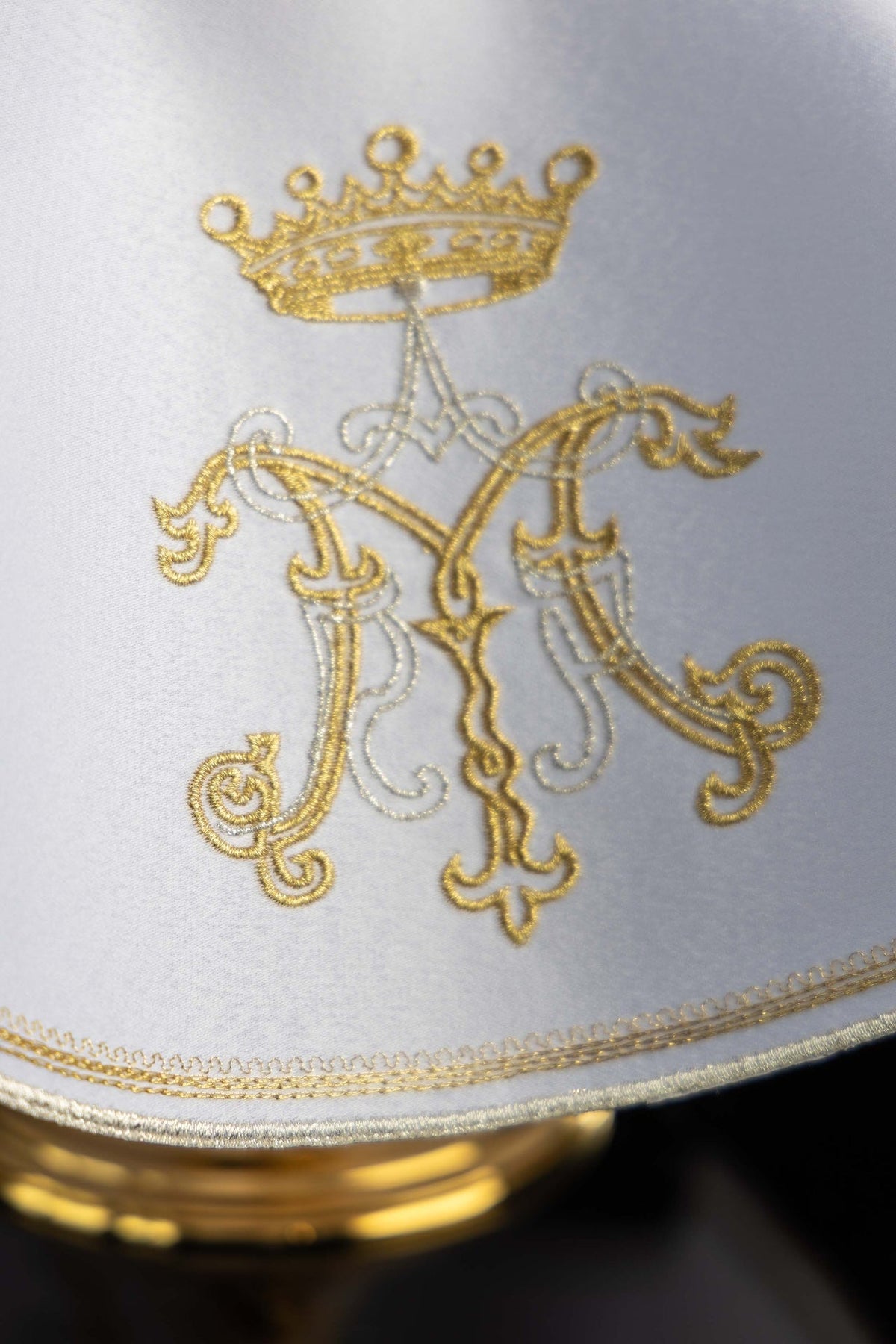 Véu de âmbula branco em close-up do bordado mariano dourado