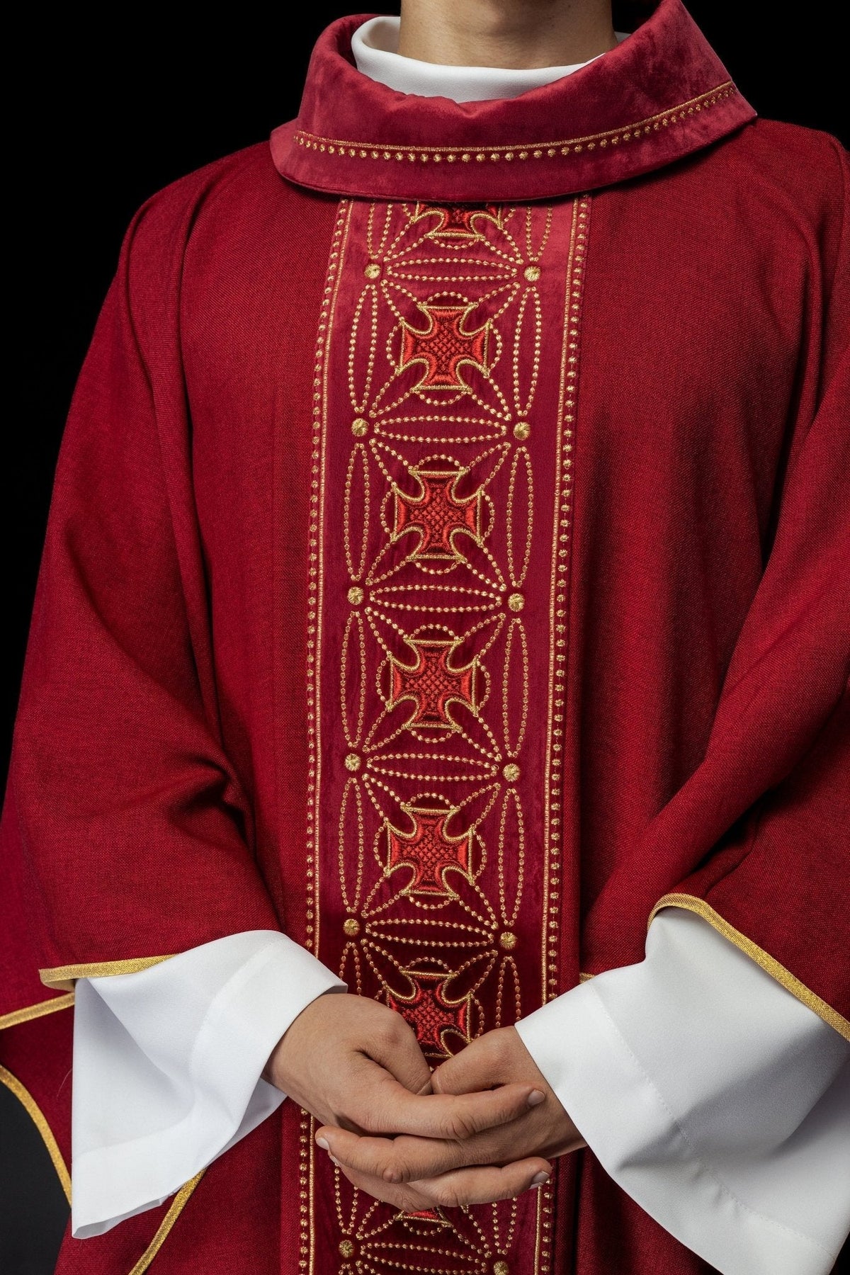 Casula vermelha com faixa frontal de cruzes bordadas, detalhe do tecido e acabamento dourado